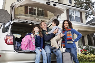 Family sitting in back of car